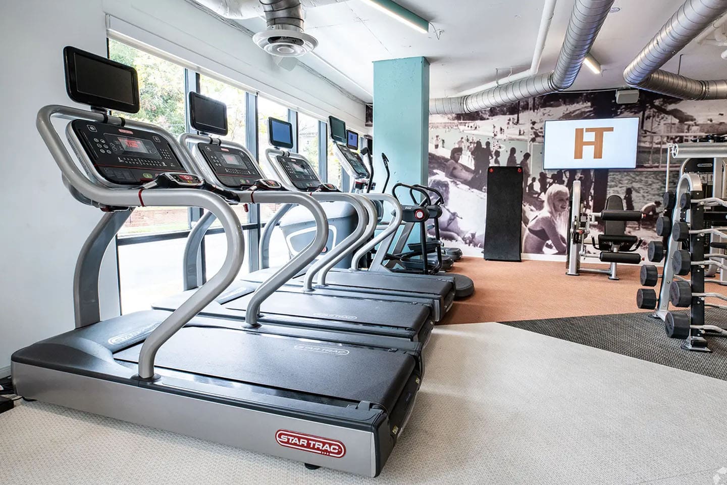 Fitness room with 3 treadmills and weight machines.