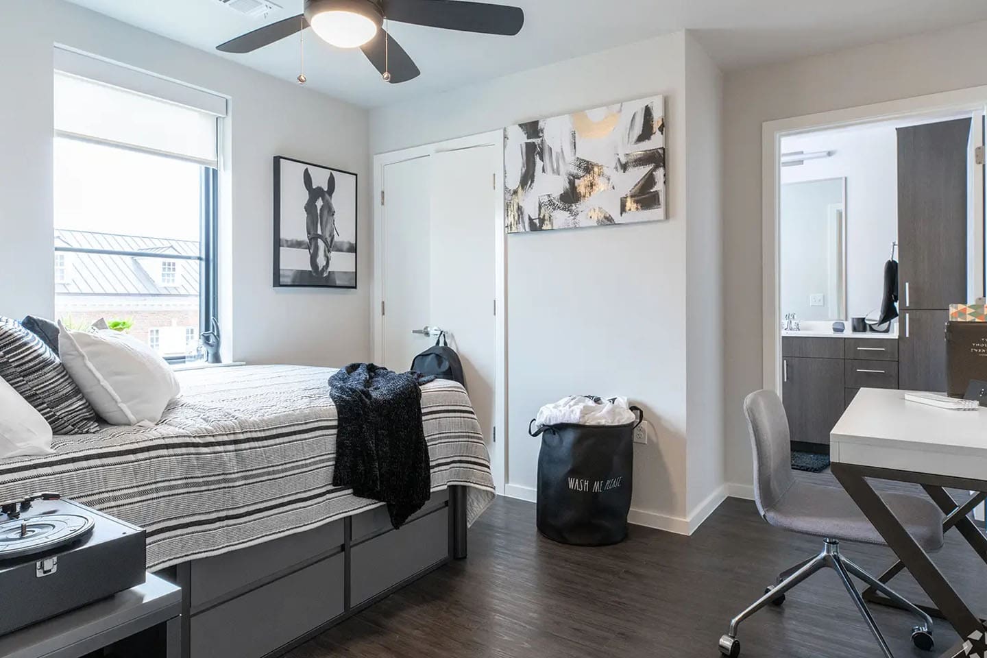 Room with bed, window, desk, closet, and a bathroom attached.